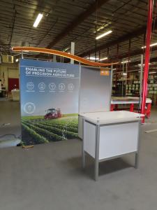 ecoSmart Sustainable ECO-1102 Exhibit with Backlit Fabric Graphic, Wave Canopy, Locking Backwall Cabinet, Monitor Mount, LED Lights, and MOD-1552 Reception Counter with Storage -- View 2